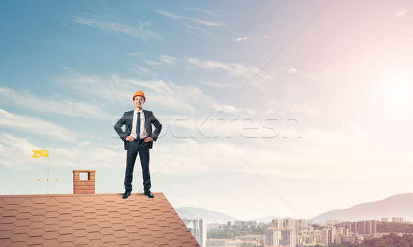 Engineer man standing on roof and looking away. Mixed media Stock photo © adam121