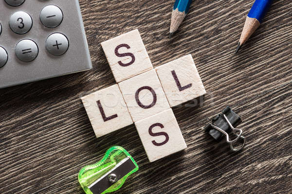 Words SOS and LOL on table made of wooden cubes elements Stock photo © adam121