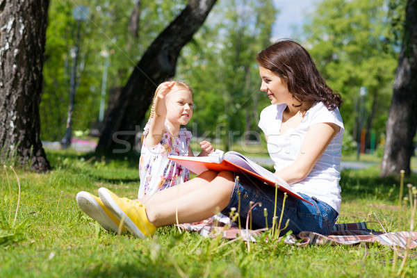 girl and a young woman reading a book together Stock photo © adam121