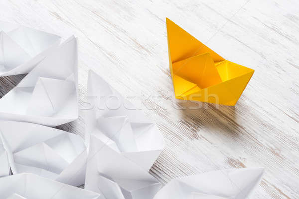 Business leadership concept with white and color paper boats on wooden table Stock photo © adam121