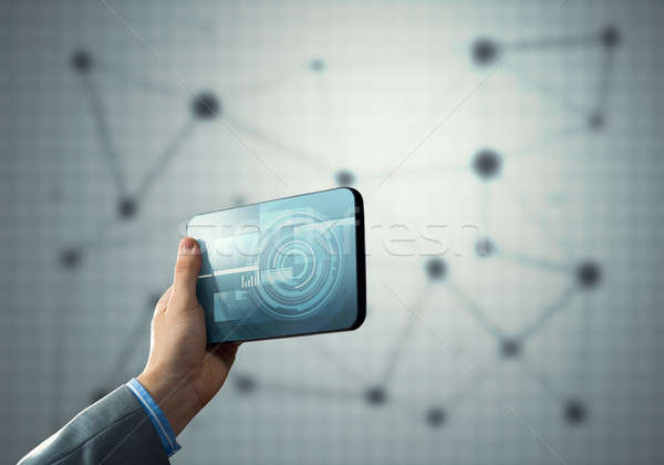 Media technology concept presented by businessman holding tablet with graphs and diagrams Stock photo © adam121