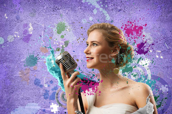 Stock photo: attractive female singer with microphone