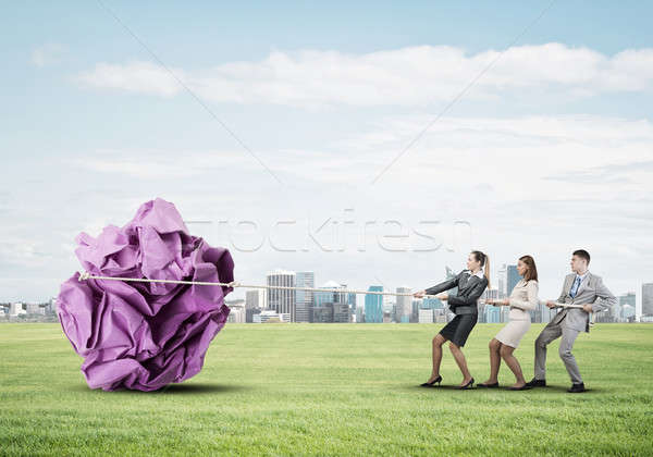 Young business people outdoors and huge paper ball as symbol of  Stock photo © adam121