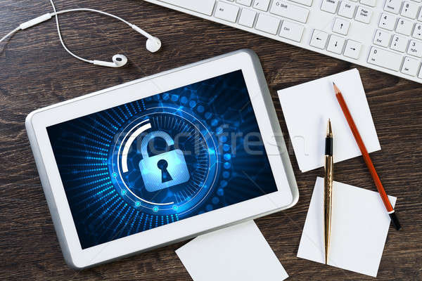 Business workplace with tablet pc and security concept on screen Stock photo © adam121