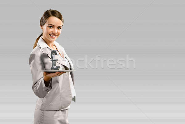 business woman holding a tablet with british pound Stock photo © adam121