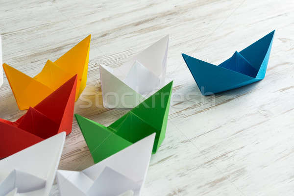 Business leadership concept with white and color paper boats on wooden table Stock photo © adam121