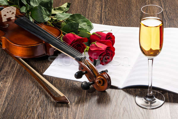 Violin, rose, glass of champagne and music books Stock photo © adam121