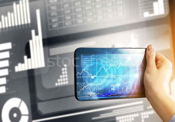 Media technology concept presented by businessman holding tablet with graphs and diagrams Stock photo © adam121