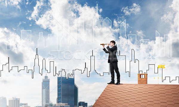 Engineer man standing on roof and looking in spyglass. Mixed media Stock photo © adam121