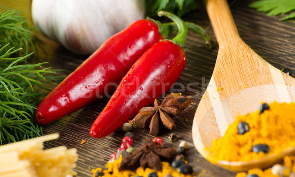 chilli, herbs and spices lie on a wooden surface Stock photo © adam121