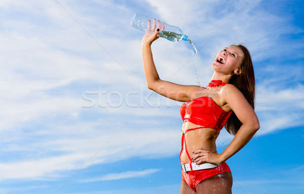 sport girl in red uniform with a bottle of water Stock photo © adam121