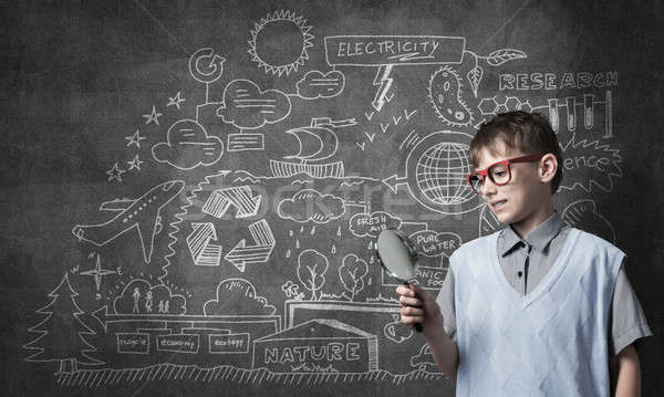 Curious school boy with magnifier Stock photo © adam121