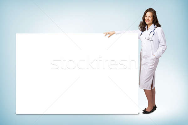 young woman doctor standing near a blank banner Stock photo © adam121