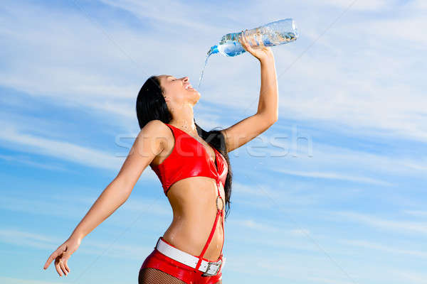 sport girl in red uniform with a bottle of water Stock photo © adam121