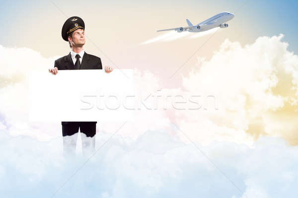 pilot in the form of holding an empty billboard Stock photo © adam121