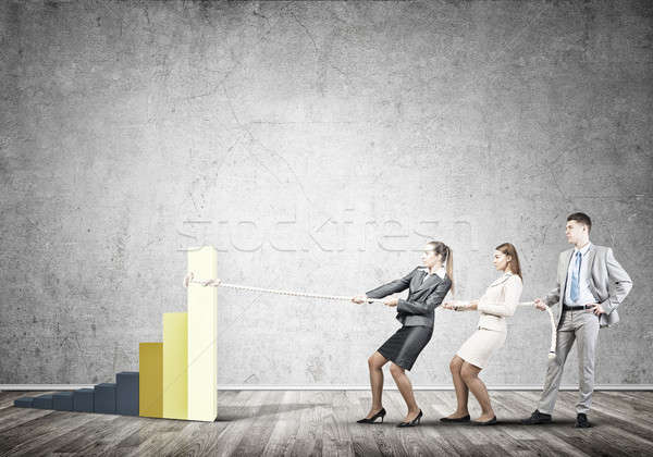 Businessteam working in collaboration pulling graph with rope as symbol of power and control Stock photo © adam121