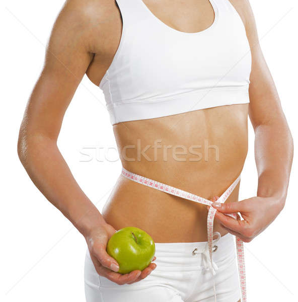 Stock photo: young athletic woman measuring waist