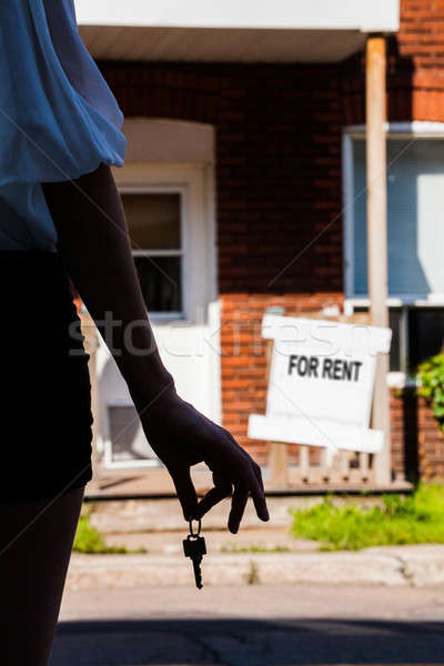 Young Woman standing in front of her new apartment Stock photo © aetb