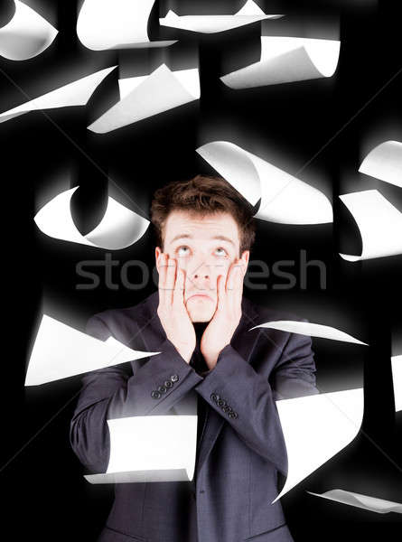 Despaired businessman with paperwork falling everywhere Stock photo © aetb