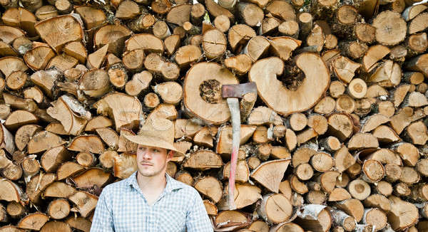 Woodcutter with straw hat on a background of wood Stock photo © aetb