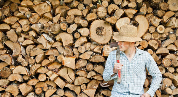 Woodcutter with straw hat on a background of wood Stock photo © aetb