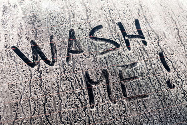 Wash Me Words on a Dirty Car Window Stock photo © aetb