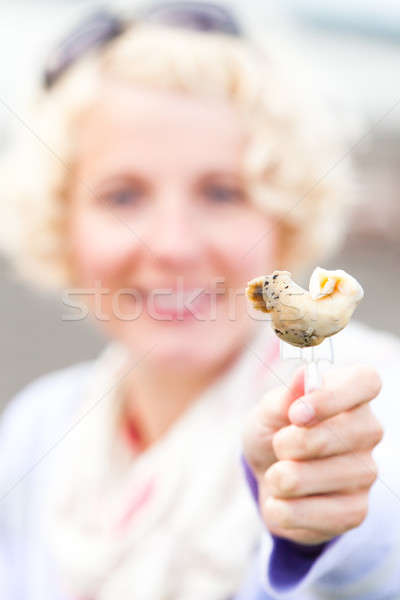 Young Woman Eating a Whelk (bourgot in french) Stock photo © aetb