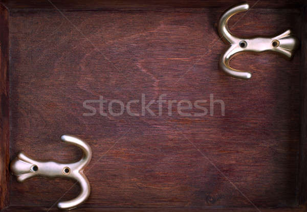 Two horizontal gold hooks into old dark box Stock photo © Agatalina