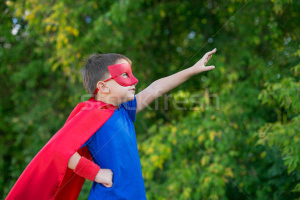 Superhero standing sideways and calling on forward Stock photo © Agatalina