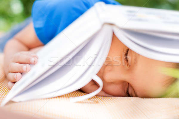 Boy sleeping undet opened book Stock photo © Agatalina