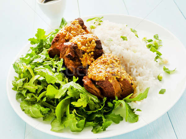 Pork ribs with rice and rucola Stock photo © AGfoto