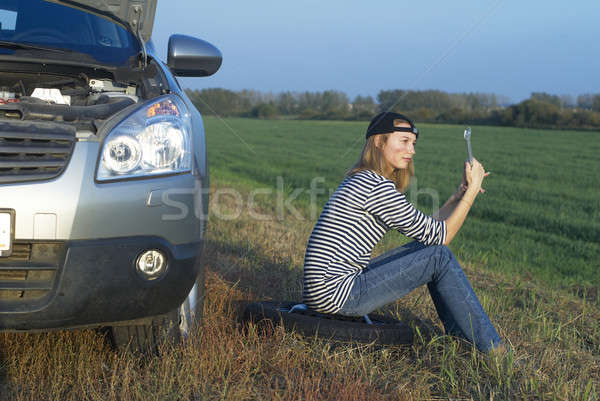 Stock photo: Young Blond Woman With Her Broken Car