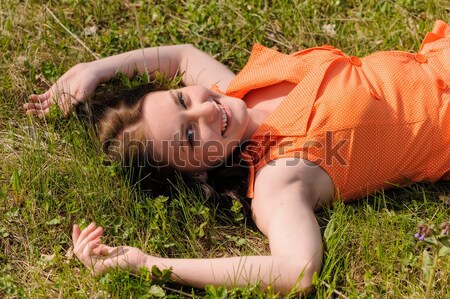 Pretty girl laying on grass Stock photo © Aikon