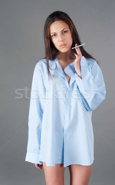 beautiful young brunette woman with cigarette Stock photo © Aikon