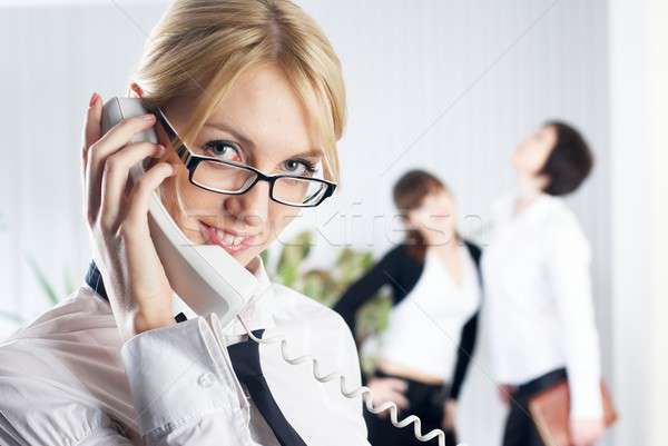 Young beautiful businesswoman calling by phone Stock photo © Aikon