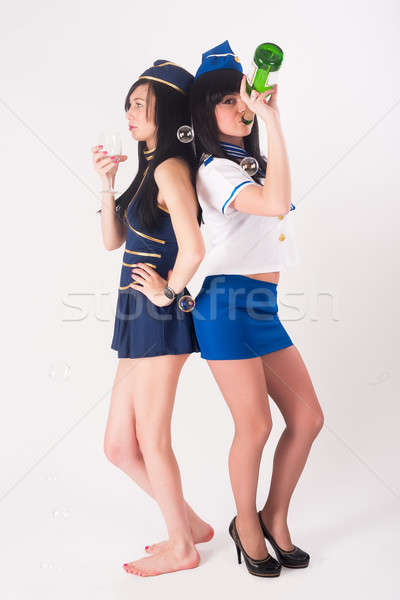 Two pretty stewardess with wine Stock photo © Aikon
