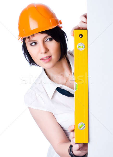 Pretty girl in helmet with level Stock photo © Aikon