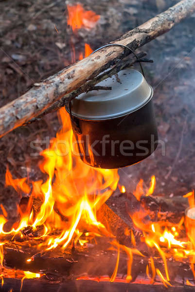 Water heating in camping kettle on fire Stock photo © Aikon