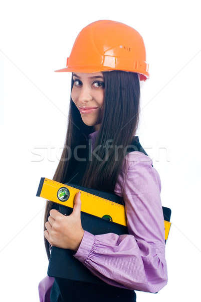 Attractive girl in helmet with level Stock photo © Aikon