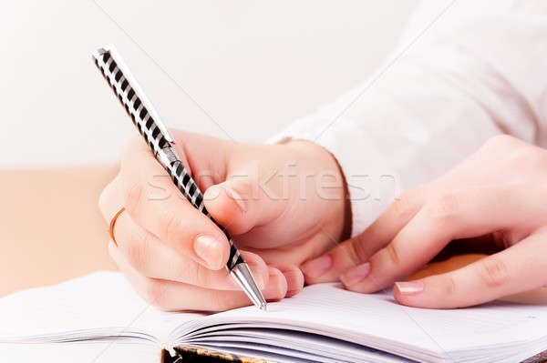 Woman writing in organizer Stock photo © Aikon