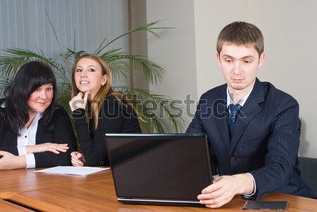 Businessman talks with colleagues in office Stock photo © Aikon