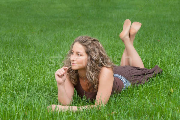 Attractive girl relaxes on grass Stock photo © Aikon