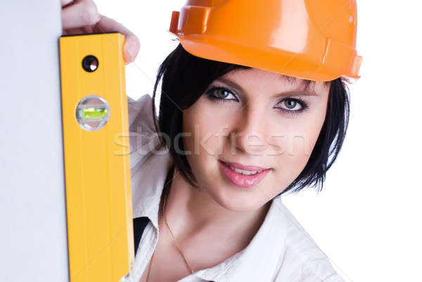 Pretty girl in helmet with level Stock photo © Aikon