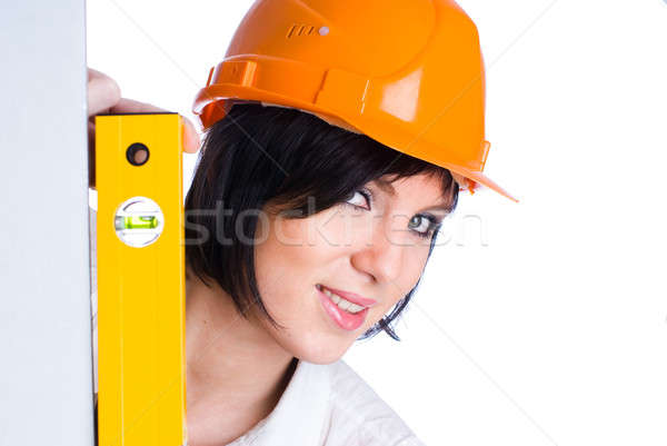 Pretty girl in helmet with level Stock photo © Aikon