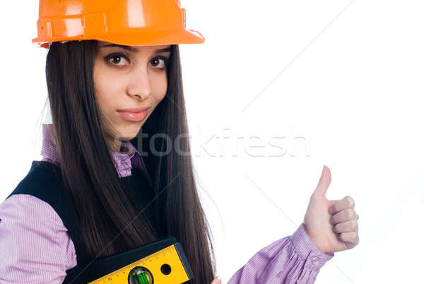 Attractive girl with level shows thumb up gesture Stock photo © Aikon