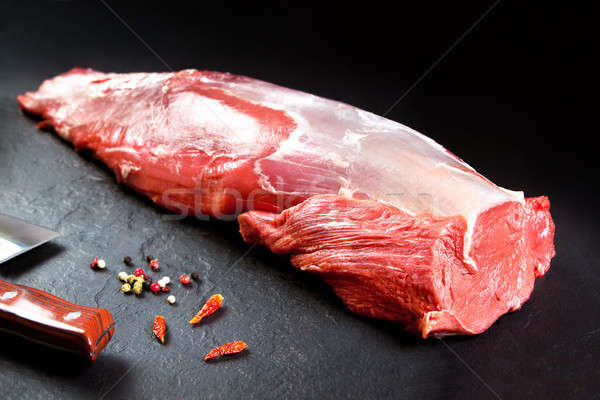 Fresh and raw meat. whole piece of Sirloin  steaks in a row ready to cook. Background black blackboa Stock photo © Ainat