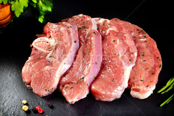 Fresh and raw meat. Turkey breast fillets in a row ready to cook. Background black blackboard Stock photo © Ainat