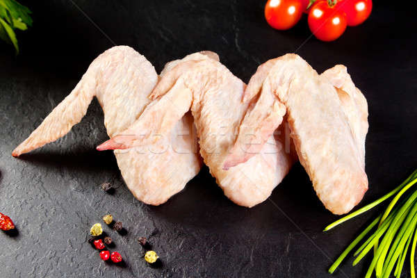 Fresh and raw meat. Chicken wings white  ready to cook. Background black blackboard Stock photo © Ainat