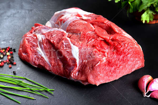 Fresh and raw meat. Still life of red meat steak ready to cook on the barbecue Stock photo © Ainat