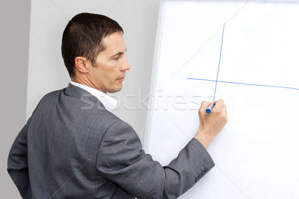 Businessman drawing on whiteboard Stock photo © ajfilgud